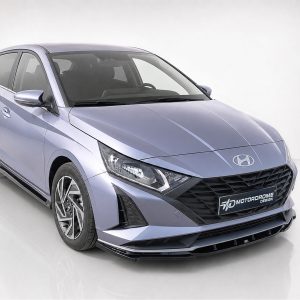 Front three-quarter view of a light purple Hyundai sedan in a studio, highlighting the grille and headlights, with a reflective floor.