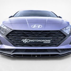 Front view of a purple Hyundai sedan with a large black grille and Motordrome Design license plate visible on the bumper.