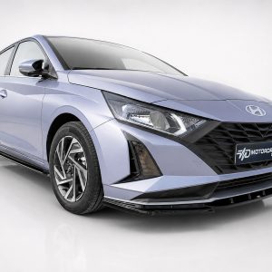 Front-right view of a metallic blue Hyundai sedan in a white studio, highlighting the large black grille and angular headlights.