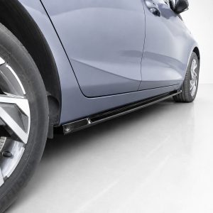 Blue car side view focusing on the front wheel and long black side skirt under the doors