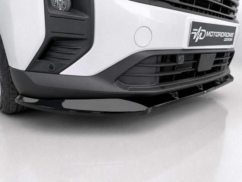Front view of a white truck with a black aftermarket front splitter/bumper lip.