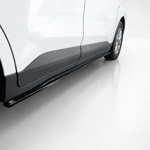 Side view of a white SUV showing black lower body cladding and a running board along the door. The rear wheel is visible in the background.