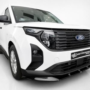 Front three-quarter view of a white Ford cargo van with black grille and blue oval logo in a studio setting, showcasing headlights and bumper details.