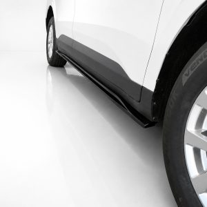 Close-up of a white car's side with a black running board/side step and a visible alloy wheel on the right side