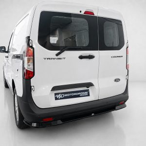 Rear view of a white Ford Transit Courier van in a studio, showing the rear doors and a branded MD MotorDrome Design plate.