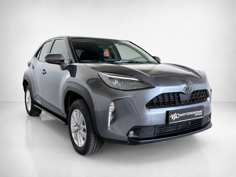 Grey Toyota crossover photographed in a studio, angled front view highlighting the grille and headlights.