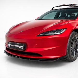 Front-left view of a bright red sports car with a sleek, aerodynamic design and a Motordrome Design license plate