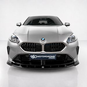 Front view of a silver BMW in a studio, showing the kidney grille and a MOTORDROME DESIGN plate on the bumper.