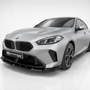 Silver BMW sedan with aggressive front splitter and black kidney grille in a studio setting, showing a custom modified design by Motorodome Design.