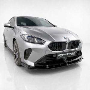 Front three-quarter view of a silver BMW with prominent black kidney grille in a white studio backdrop, showcasing its sleek lines and headlights.