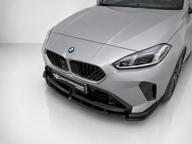 Front view of a silver BMW with distinctive kidney grille and LED headlights in a studio setting.