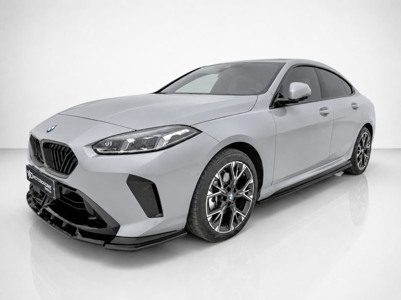 Front three-quarter view of a silver BMW sedan in a studio setting, featuring a large black kidney grille and stylish alloy wheels.