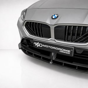 Front view of a silver BMW with a large black kidney grille and BMW emblem on the hood.