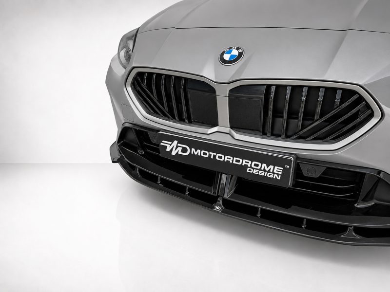 Front view of a silver BMW with a large black kidney grille and BMW emblem on the hood.
