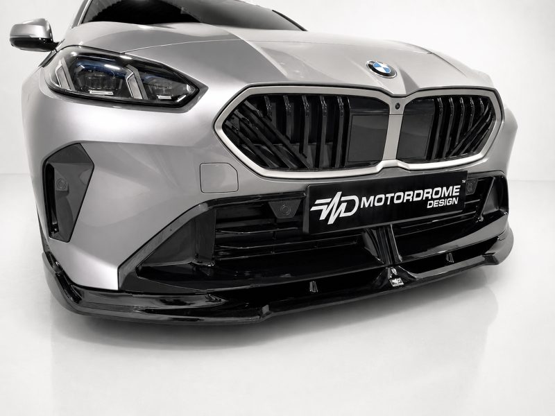 Close-up of a silver BMW-style front end with a bold black kidney grille and aggressive bumper features.