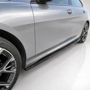 Side view of a silver BMW sedan, highlighting the front wheel, door, and glossy body panel.