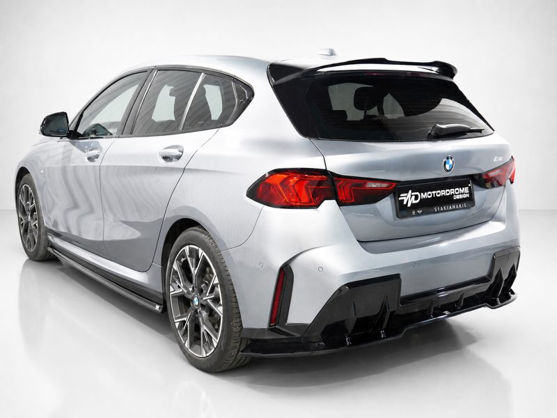 Rear three-quarter view of a silver BMW hatchback with large alloy wheels and a black rear spoiler in a studio setting, showing curvy body lines and red taillights.