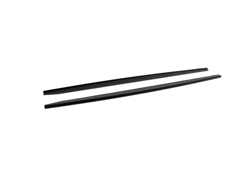 Two parallel black metal bars with evenly spaced rivet holes laid diagonally on a white background (roof rack crossbars).