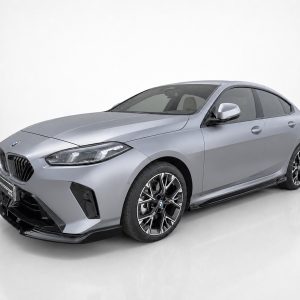 3/4 front view of a silver BMW sedan in a studio, highlighting the large black kidney grille and sharp headlights