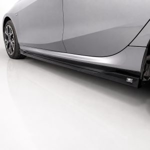 K215-004_2jpg - OPSHOLDERS Side view of a gray car highlighting the aerodynamic side skirt and alloy wheel on a clean floor surface.