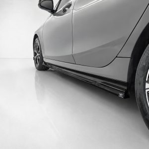 Gray sports car's side close-up, showing a lowered body and glossy side skirt near the wheel edge.