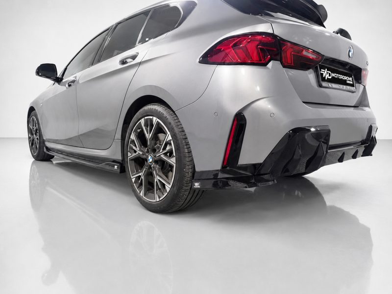 K215-004_4jpg - OPSHOLDERS Rear three-quarter view of a silver BMW with a carbon fiber aero kit in a studio setting.