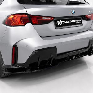 Rear of a silver BMW with a black Motordrome Design plate, featuring an aggressive diffuser and red tail lights