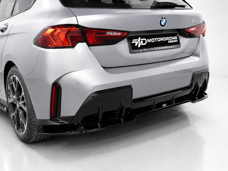 Rear of a silver BMW with a black Motordrome Design plate, featuring an aggressive diffuser and red tail lights