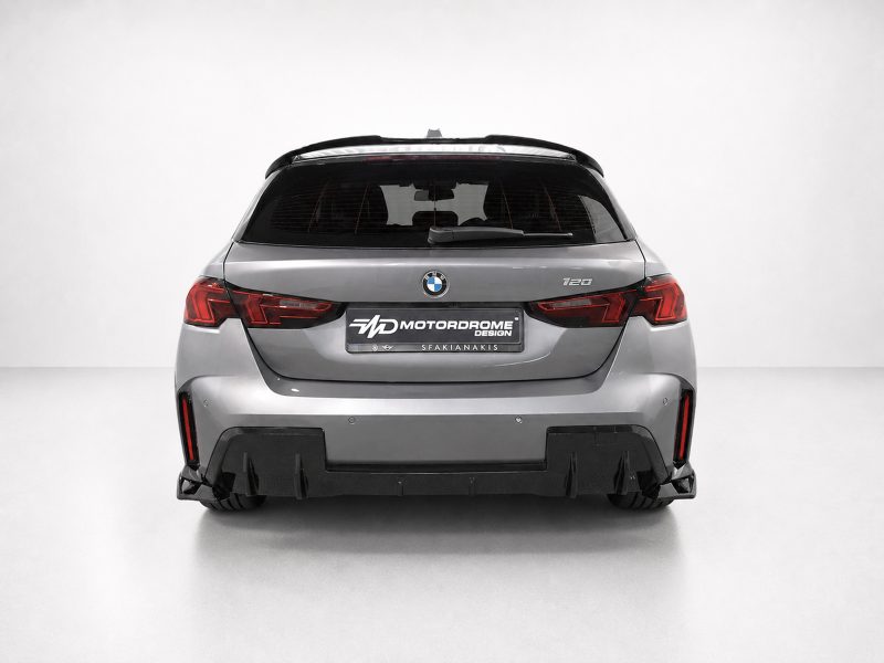 K215-006_4jpg - OPSHOLDERS Rear view of a silver BMW SUV with red taillights and a Motordrome Design plate visible on the license area.