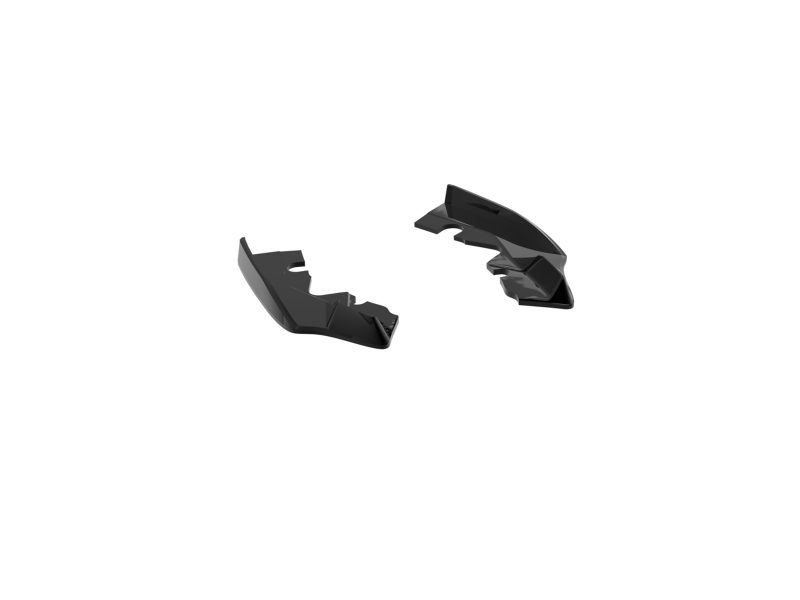 K215-006_5jpg - OPSHOLDERS Two glossy black plastic fragments separated on a white background, looking like broken pieces of a curved object.