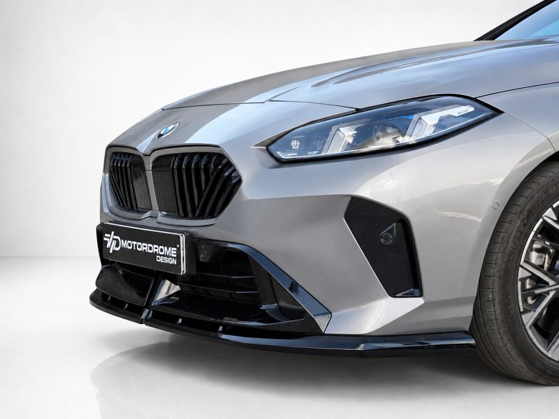 Front-left view of a silver BMW with prominent kidney grille, sleek LED headlight, and a Motordrome Design plate at the bumper