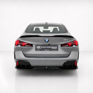 Rear view of a gray BMW 220 in a white studio, with red taillights and a showroom MD MotorDrome plate
