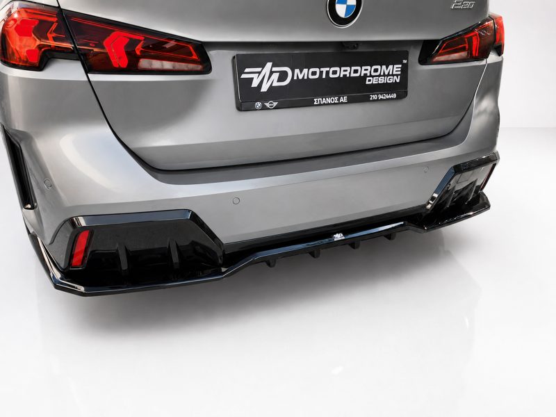 K215-008_3jpg - OPSHOLDERS Rear view of a silver BMW with a black Motordrome Design plate and sporty, aggressive bumper details