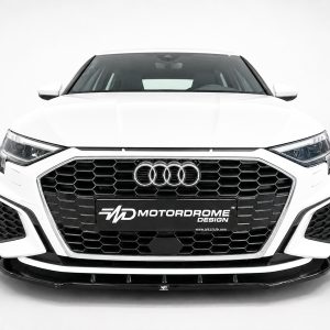 Front view of a white Audi SUV with a large black honeycomb grille and four-ring emblem.