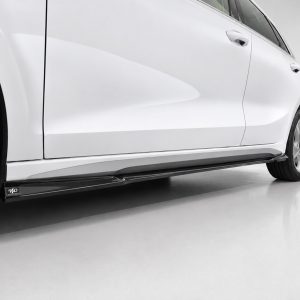 Side view of a white car, highlighting the smooth body line, door, and alloy wheel with a glossy floor reflection.