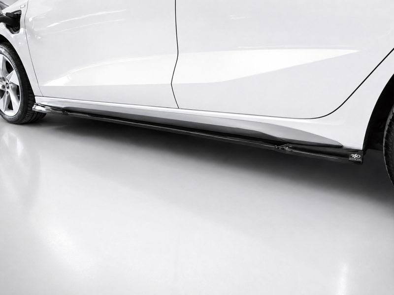 Close-up of a white car's lower side panel and side skirt, with a chrome trim and visible wheel on the left.