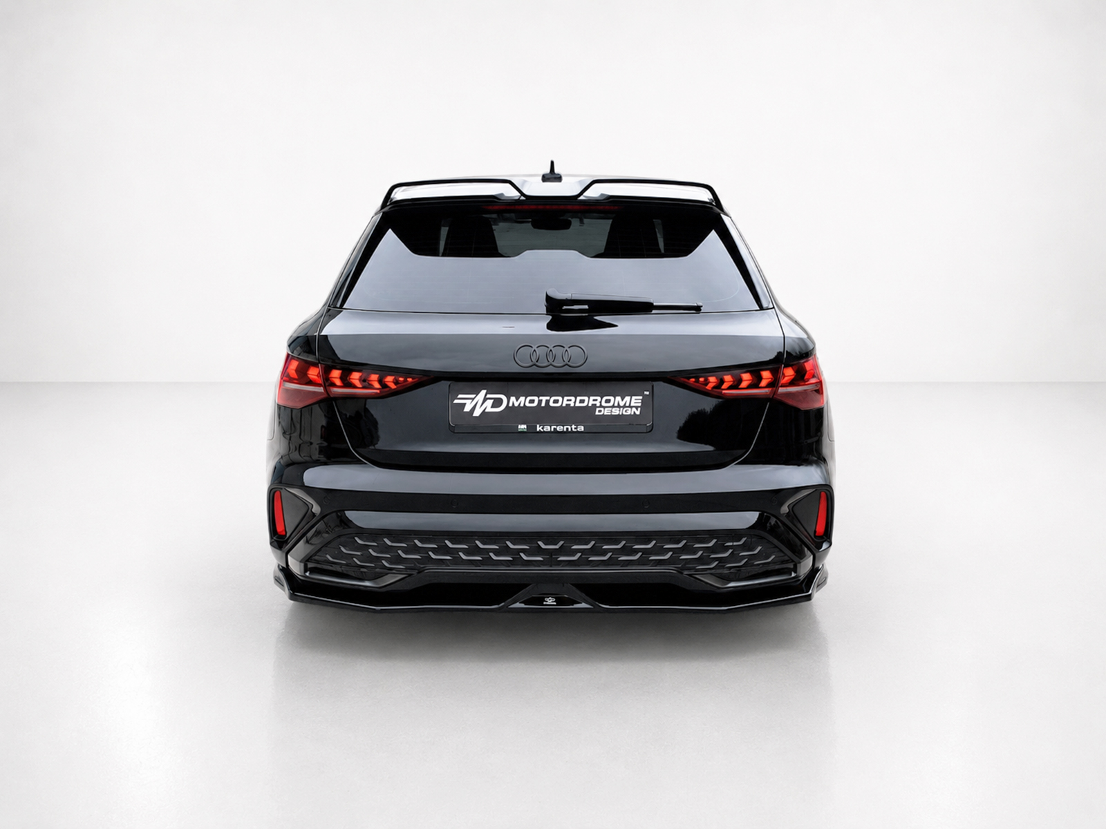 K216-005_1jpg - OPSHOLDERS Rear view of a black Audi SUV in a white studio, with red LED taillights and a Motordome Design license plate.