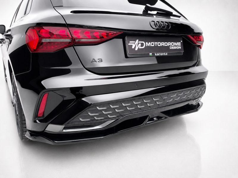 K216-005_3jpg - OPSHOLDERS Rear view of a glossy black Audi A3, showing distinctive taillights and a Motordrome Design plate on the trunk