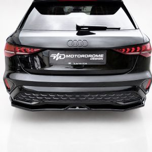 K216-005_4jpg - OPSHOLDERS Rear view of a black Audi SUV with a Motordrome Design plate on a white showroom backdrop
