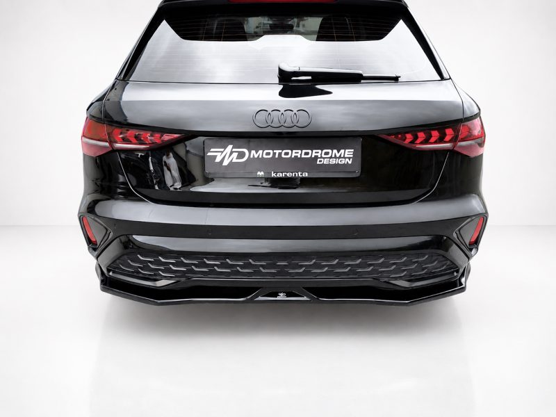 K216-005_4jpg - OPSHOLDERS Rear view of a black Audi SUV with a Motordrome Design plate on a white showroom backdrop