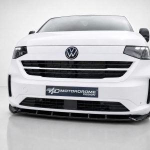 Front view of a white Volkswagen van with emblem visible and a Motordrome Design plate on the bumper