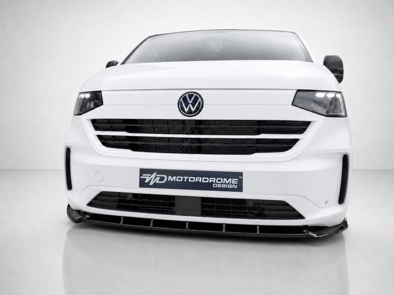 Front view of a white Volkswagen van with emblem visible and a Motordrome Design plate on the bumper