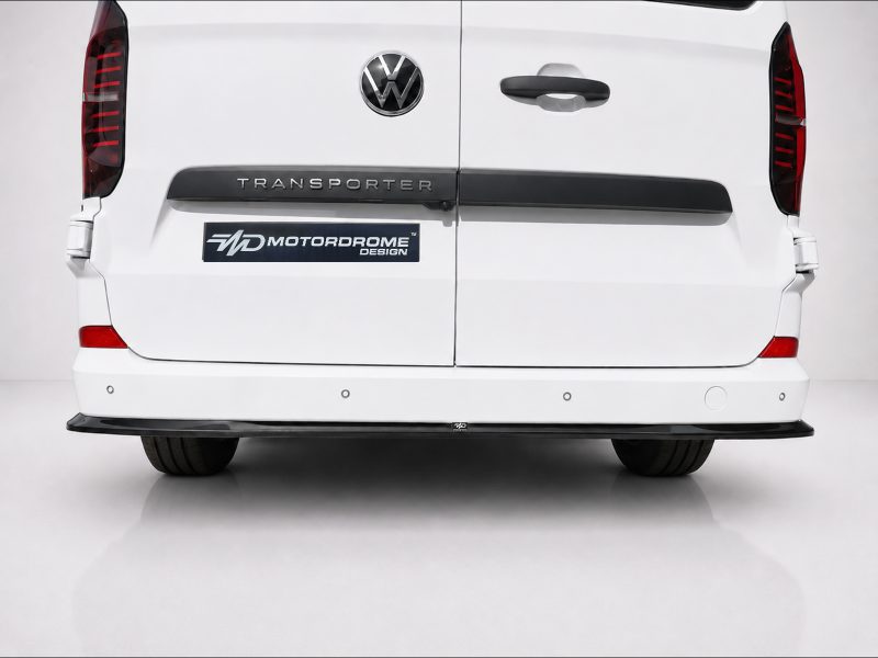 K217-006_4jpg - OPSHOLDERS Rear view of a white Volkswagen Transporter van with VW emblem and a MotorDrome Design badge on the left tail area.