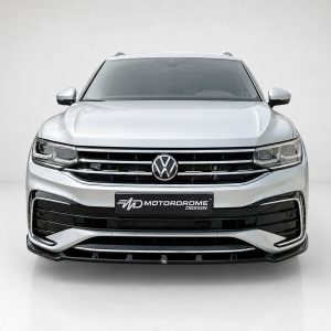 Front view of a silver Volkswagen SUV with a chrome grille and VW emblem, indoors on a light background.