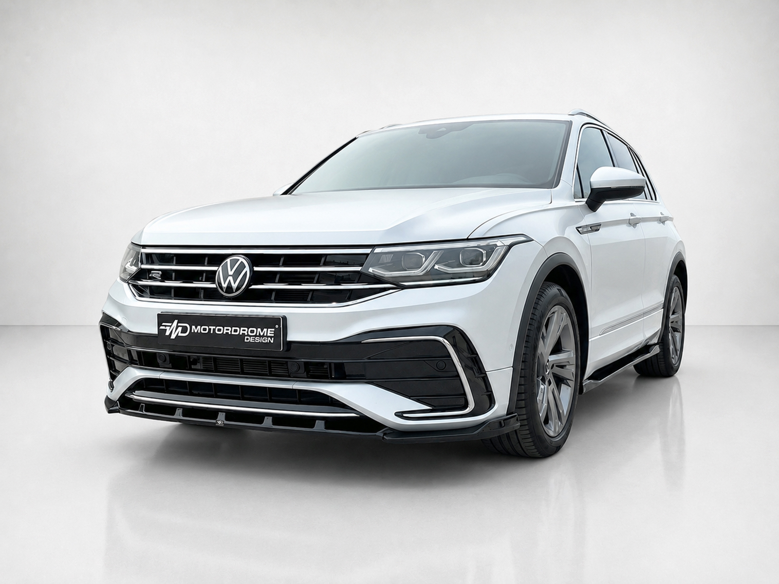 K218-001_2jpg - OPSHOLDERS Front three-quarter view of a white VW SUV with chrome grille and black lower bumper, displaying a Motordrome Design plate on the front bumper.