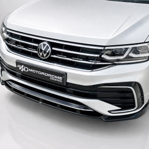K218-001_3jpg - OPSHOLDERS Front view of a silver Volkswagen SUV showing chrome grille and prominent LED headlights with a Motordrome Design plate on the bumper.