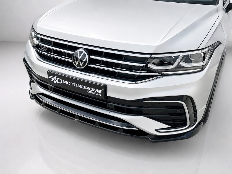 K218-001_3jpg - OPSHOLDERS Front view of a silver Volkswagen SUV showing chrome grille and prominent LED headlights with a Motordrome Design plate on the bumper.