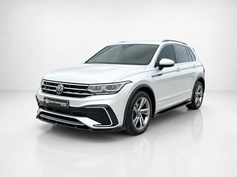 K218-001_4jpg - OPSHOLDERS Front three-quarter view of a white Volkswagen SUV in a studio setting with a chrome grille and alloy wheels.