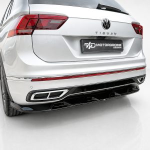 Rear view of a white Volkswagen Tiguan with a MOTORDROME DESIGN license plate and red taillights.