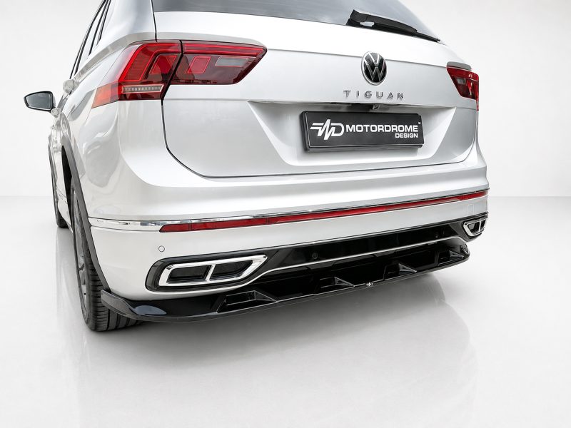 Rear view of a white Volkswagen Tiguan with a MOTORDROME DESIGN license plate and red taillights.